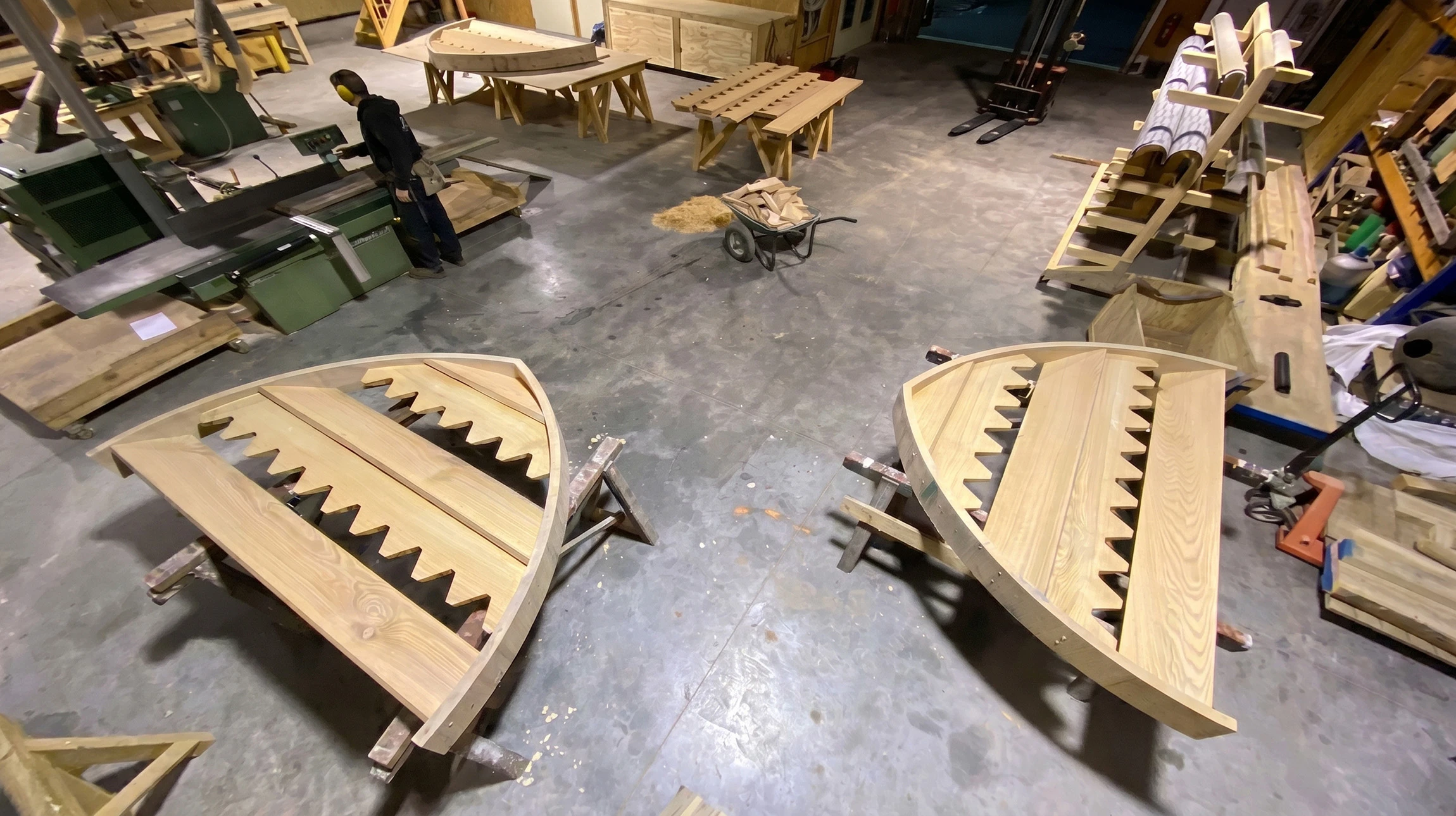 Intérieur d'un bâtiment en construction montrant la charpente en bois apparente vue du dessous